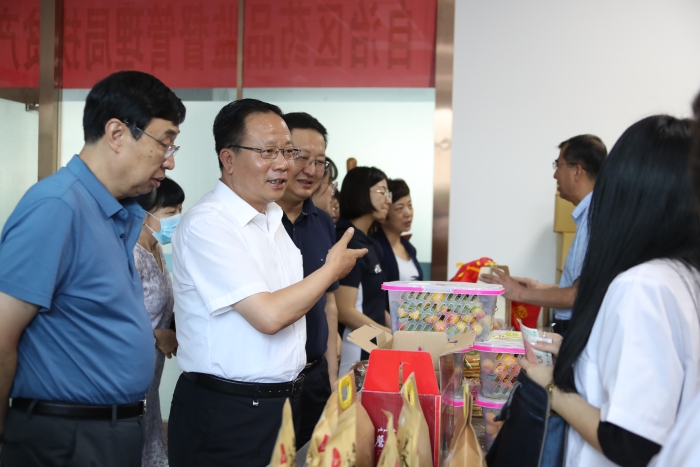 新疆維吾爾自治區(qū)藥監(jiān)局黨組書記、局長張鈺祥（左二）等局領(lǐng)導帶頭搶購。（馬少賓 攝）