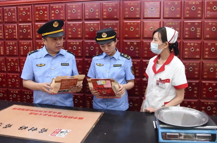 圖為執(zhí)法人員正在一家藥品經(jīng)營企業(yè)抽檢中藥飲片。